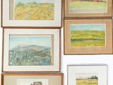 many paintings hanging on the wall of a room