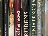 many books that are on a shelf in the room
