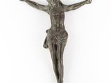 a bronze statue of jesus on the cross on a white background