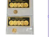 two gold coins are in a clear plastic case on a white background