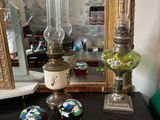 three glass vases on a black table with a mirror in the background