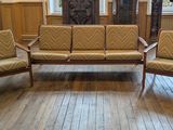 three chairs and a couch in a room with wood floors