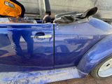 a blue car that has been painted blue and is parked on the side of the road