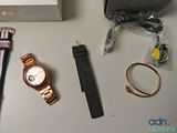 a watch, bracelets, and other items on a table