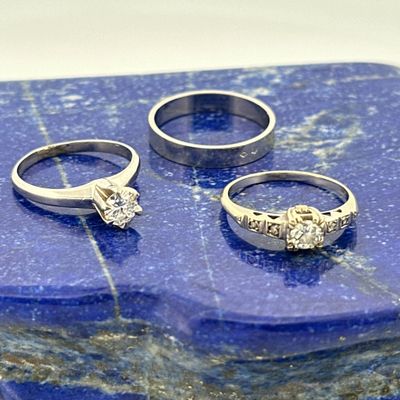 three wedding rings sitting on top of a blue marble slab