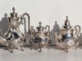 many silver objects sitting on a white surface