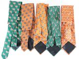 several different colored ties are lined up on a white surface