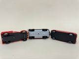 three toy trains sitting next to each other on a white surface