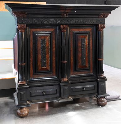 a black and brown cabinet that is on display in a room