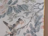 a picture of two birds sitting on a branch of a tree