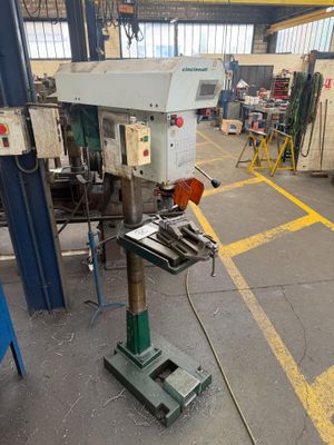 an image of a machine in a factory with a lot of tools