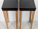 pair of black and wood side tables with black tops