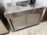 a stainless steel counter with a coffee maker on top of it