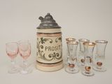 bottles and glasses are lined up on a white surface