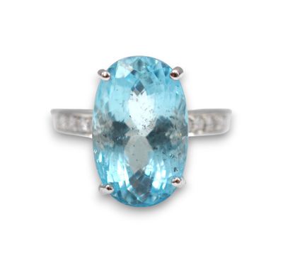 a close up of a ring with a blue topazt stone