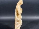 carved ivory figurine of a woman holding a baby