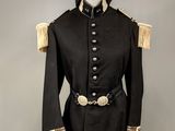 a black uniform with gold trims and buttons on a mannequin