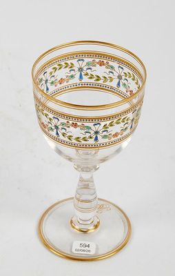 a close up of a glass with a gold rim on a white background