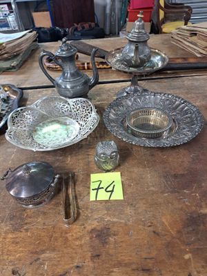 une table en bois sur laquelle sont posés de nombreux objets en argent
