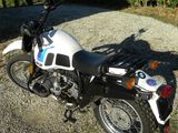 a motorcycle that is parked on a gravel road