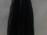 a black dress on a mannequin mannequin with a white background