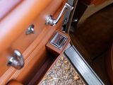 a close up of a brown leather car door handle