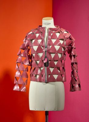 pink leather jacket on a mannequin mannequin with a red background