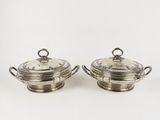 a pair of silverplated dishes with handles and handles