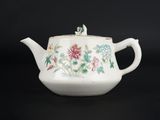 une théière blanche ornée d'un motif floral