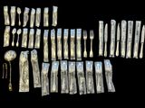 a lot of silverware on a black background