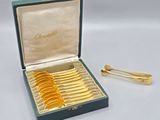 a box with a bunch of gold spoons in it