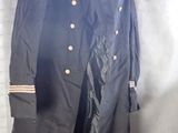 an image of a black military coat hanging on a wall