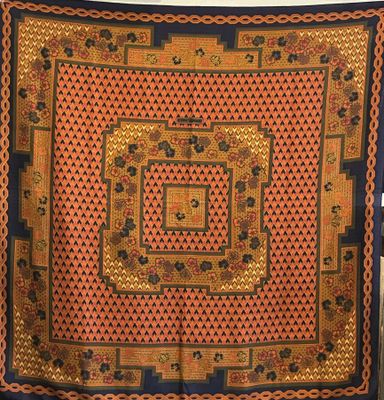 an orange, black and blue scarf with a square design on it