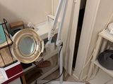 a lamp that is sitting on a stand in the corner of a room