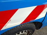 a red and white stripe on the side of a blue car
