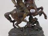 statue of a man riding a horse with a sword on top of it
