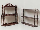 pair of antique wooden bookshelves on display against a white wall