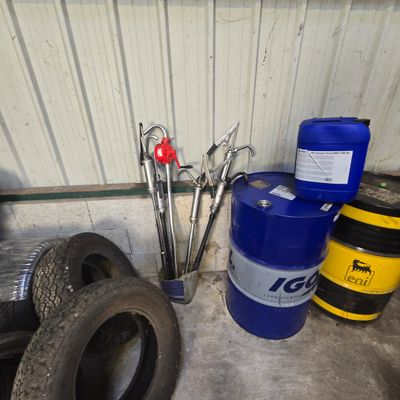 a blue barrel and a pair of scissors sitting next to a blue barrel