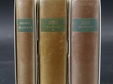 three books sitting on top of each other on a table
