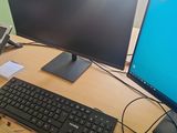 a computer desk with two monitors, a keyboard, and a mouse