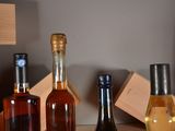 three bottles of wine sitting on a table next to each other