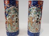 pair of chinese vases on a white table with a white background