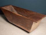 an old wooden bath tub sitting on top of a white counter