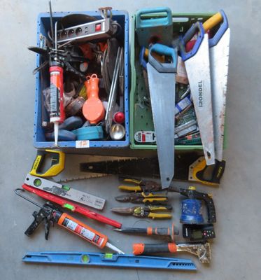 many different tools in a box on the floor