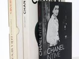 two books sitting on top of a white table next to each other