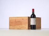 a bottle of wine sitting next to a wooden box