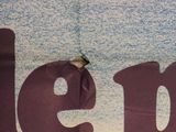 a bird that is sitting on a sign that says help