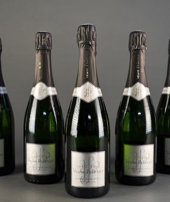 six bottles of champagne are lined up in a row on a table