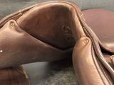 a close up of a pair of brown shoes on a table