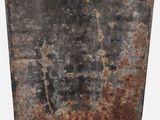 rusted metal plate with a hole in the middle on a white background